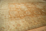 Soft, lustrous gold pile with floral palmettes and a beige cartouche border.