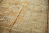 Plush Indian Oushak pile with high luster, showing beige and copper floral motifs.
