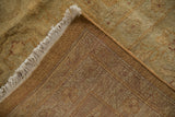 Tightly hand-knotted back, cream fringe, and plush golden wool pile of the rug.