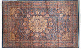 Finely knotted thousand flower motif with terracotta and saffron blossoms covering the deep indigo blue field.