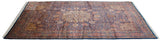 Angled perspective of a vintage Ardebil design carpet's intricate floral pattern and indigo blue field.