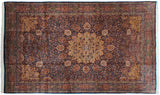 Saffron yellow medallion and corner spandrels over an indigo blue field with a dense thousand-flower motif.