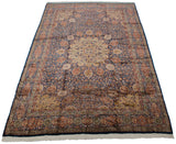 Vintage Pakistani Ardebil carpet viewed from an angle, displaying its full length and central medallion.