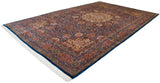 Angled view of the vintage Ardebil carpet, showcasing its grand scale, central medallion, and indigo floral field.