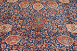 Close-up of the thousand flower design motif with rust and saffron florals on an indigo blue field.