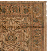 Agra carpet corner featuring scrolling palmettes, serrated leaves, beige, green, and copper with fringe.