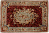 Indian Savonnerie carpet with a central floral medallion on a deep red field with slate blue borders.