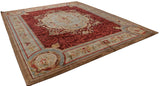 Low angle on a cherry red and slate blue Savonnerie rug, showing its full, lustrous wool pile.