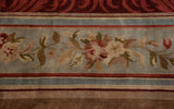 Rococo scrolling on a cherry red border next to floral bouquets on a slate blue ground.