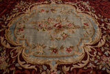 Detail of a Savonnerie carpet's Rococo medallion with a floral spray on a slate blue ground.