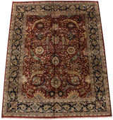 Angled view of a vintage Safavid reproduction carpet with a cherry red field and navy floral border.