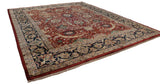 Complex navy border and cherry red field on a vintage hand-knotted Isfahan design carpet.