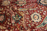 Lush wool pile showing serrated leaves and scrolling vinery in gold, emerald green, and pale blush.