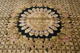 Contrasting roundel medallion with a pointed contour, shown on the lush black and gold geometric field.