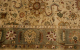 Delicate floral vinery and cloud bands on ivory field to olive green border.