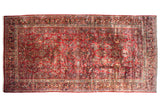 Vintage American Sarouk carpet with a dense, allover floral pattern over a deep cherry red field.