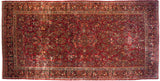 Corner detail of a vintage Sarouk rug highlighting intricate floral borders and the original side selvage.