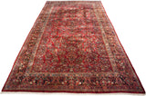 A fine American Sarouk carpet shown lengthwise, featuring its allover floral design on a cherry red ground.