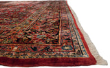 Intricate navy floral border and lush cherry red pile on a fine vintage American Sarouk carpet.
