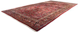 Angled view of a large vintage American Sarouk carpet with its dense, allover floral pattern.