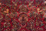 Close view of lotus flowers and botehs on a fine vintage American Sarouk carpet with a dense red pile.