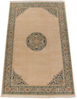 Full length view of a Japanese Peking carpet showing its medallion, spandrels, and floral border.