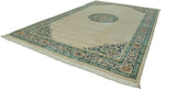 Perspective view of the vintage Peking carpet showing its ivory field, medallion, and floral border.