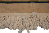 Hand-knotted ivory fringe showing minor fragility on the vintage Japanese Peking carpet.