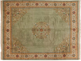 Vintage Japanese Peking rug corner detail: sage green field, ivory border, scrolling vines, and geometric spandrel.