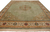 Vintage Japanese Peking rug corner, sage green field with scrolling vines and Greek key border.