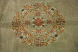 Dense scrolling vines and mauve flowers on sage green vintage Japanese Peking design.