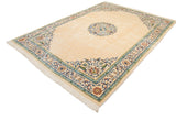 Vintage Japanese Peking carpet viewed from an angle, showing the floral medallion on its open ivory field.