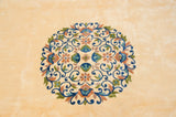 Densely ornamented roundel medallion with scrolling vines in blue, mauve, and aqua green.