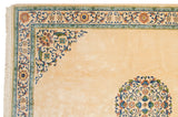 Dense scrolling vines in the corner spandrel and floral border of a vintage Peking design carpet.