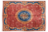 Vintage Japanese Aubusson design carpet with a blue floral medallion and gold rococo details on a dusty raspberry field.