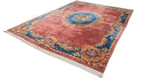 Vintage Japanese Aubusson carpet seen from an angle, showing the raspberry field and blue floral border.