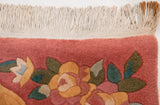 Minor rust-toned staining visible on the ivory fringe of the vintage Japanese floral carpet.