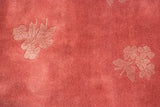 Shadow floral sprays in a design relief on the vintage rug's dusty raspberry pile.