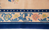 Peking rug border detail with ivory, blue, blush, and gold floral vines.