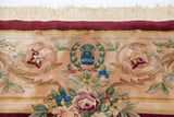 Japanese Savonnerie design carpet: blue weaver insignia, rose bouquets, red border, and cream fringe.