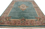 Japanese Savonnerie carpet featuring aqua green blue field, ornate rose border, and visible fringe.