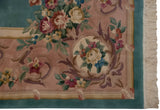 Japanese Savonnerie rug corner with mauve vinery, rose bouquets, aqua border, and ivory fringe.