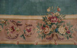 Japanese Savonnerie border: dense rose bouquets, scrolling vinery, mauve ground, aqua field.