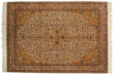 Hand-knotted floral borders and saffron corner on a vintage Isfahan design carpet.