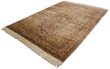 Vintage Isfahan design carpet seen from an angle, highlighting its intricate floral pattern and detailed border.