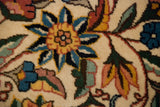 Close-up of dense floral arabesques in saffron, cobalt blue, and blush on an ivory field.