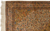 The corner of a vintage Isfahan design carpet, showing its detailed floral borders and original side cord selvage.