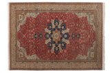 Vintage Kaisary carpet with a navy starburst medallion on a brick red floral field and ivory borders.