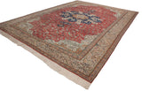 Angled perspective of a vintage Kaisary carpet showing its central medallion, brick red field, and floral borders.