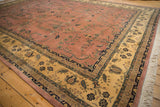 Vintage Mohajeran Sarouk carpet corner, dusty rose field, sprawling vines, antique ivory border, and fringe.